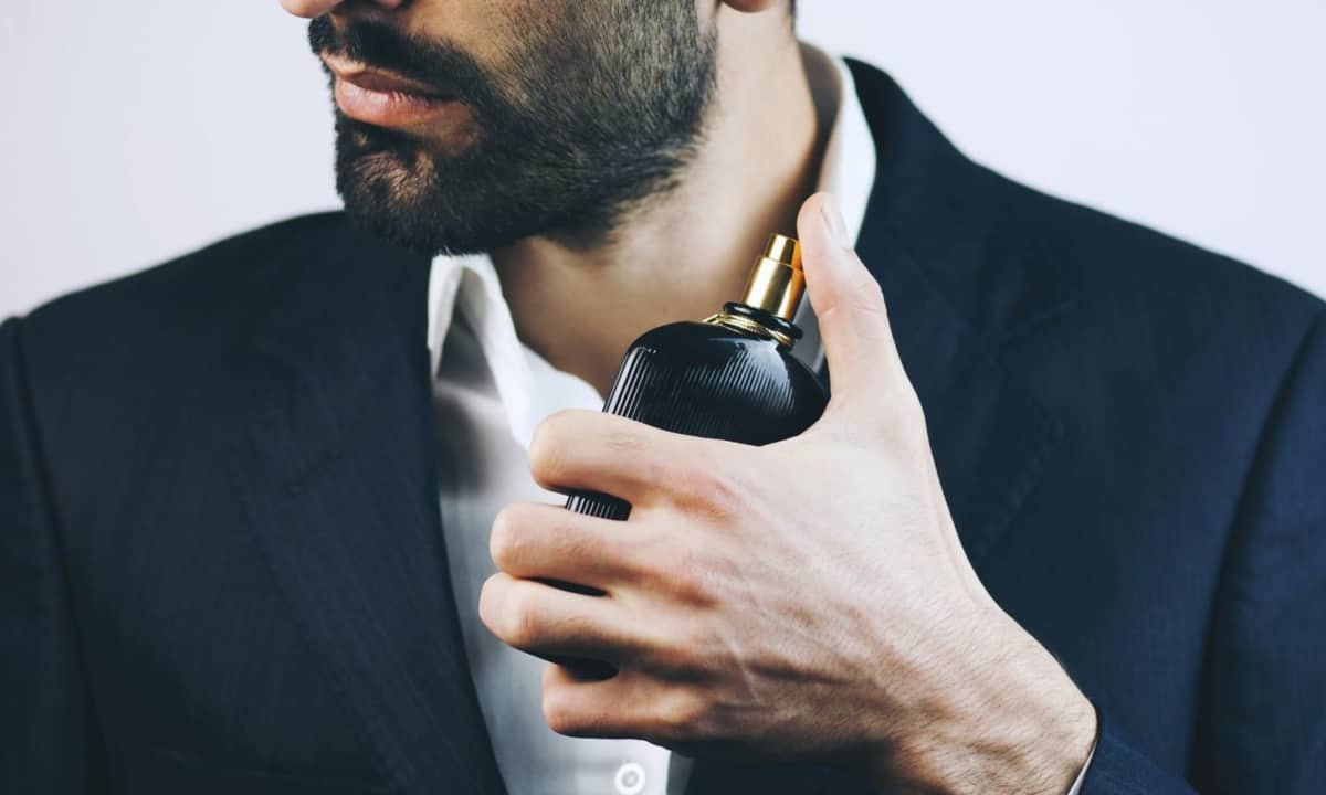 Handsome man spraying fragrance